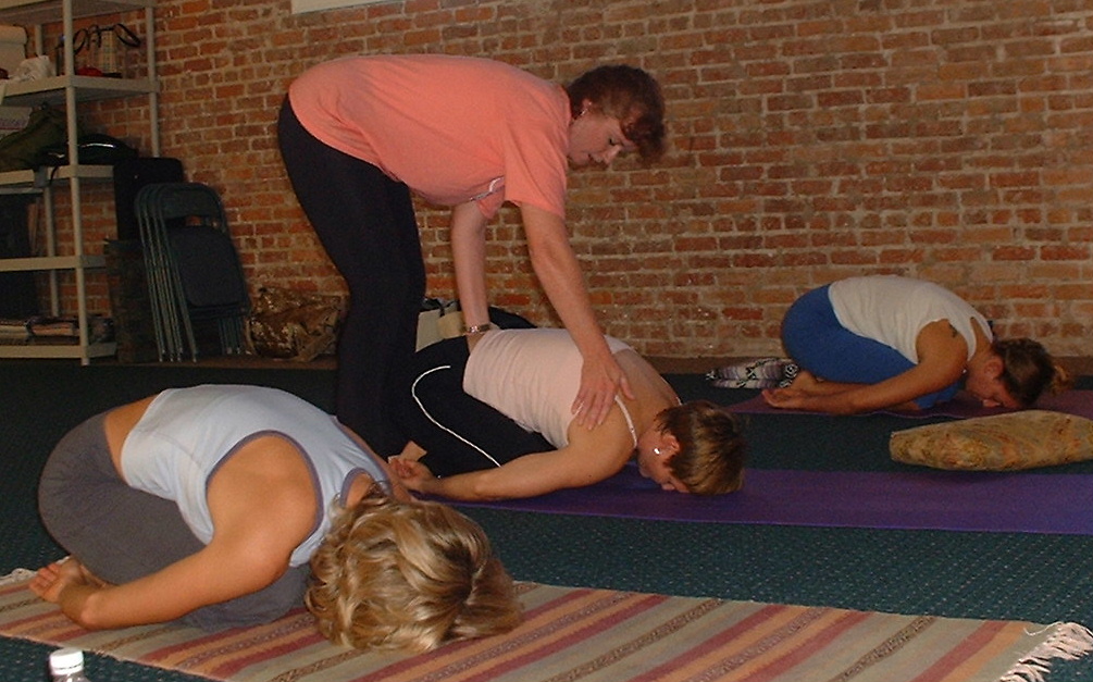 Carol assists Child Pose